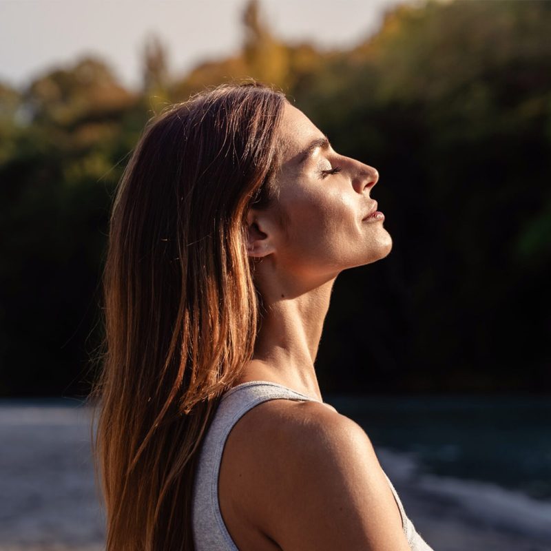 Woman looking into the sun