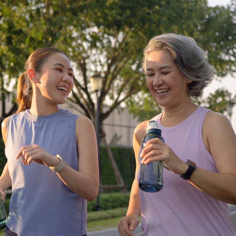 Two women walking with drink bottles