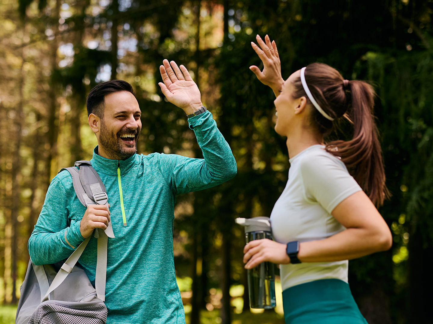 Man and woman in gym gear give each other high-five